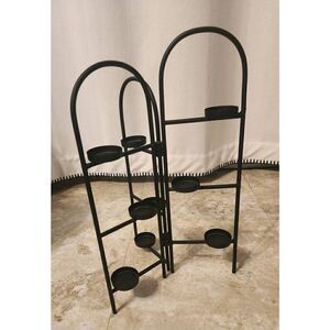 Decorative standing black metal with small glass votive candle holders
